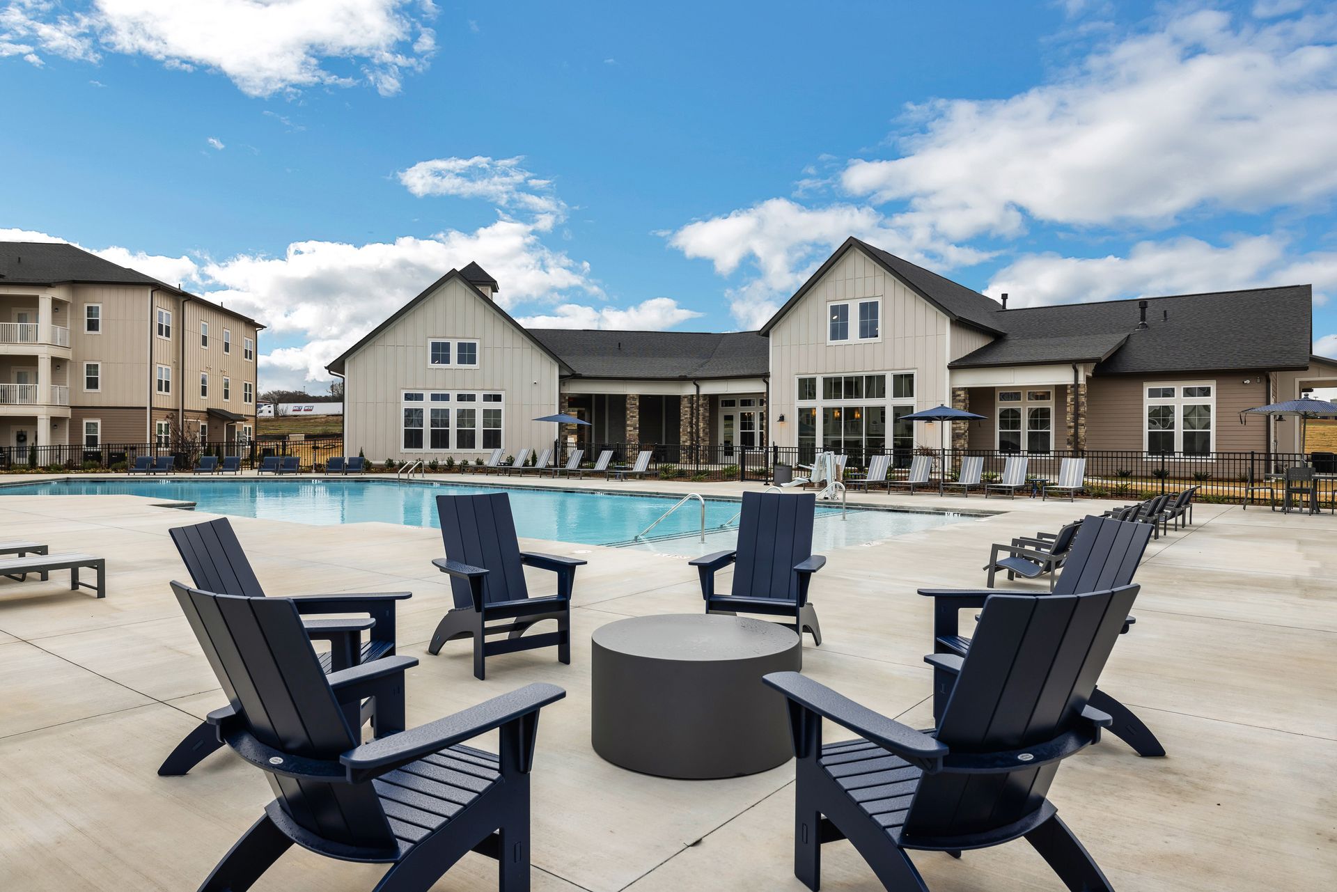 A group of chairs are sitting in front of a swimming pool at The Standard at Pinestone. 