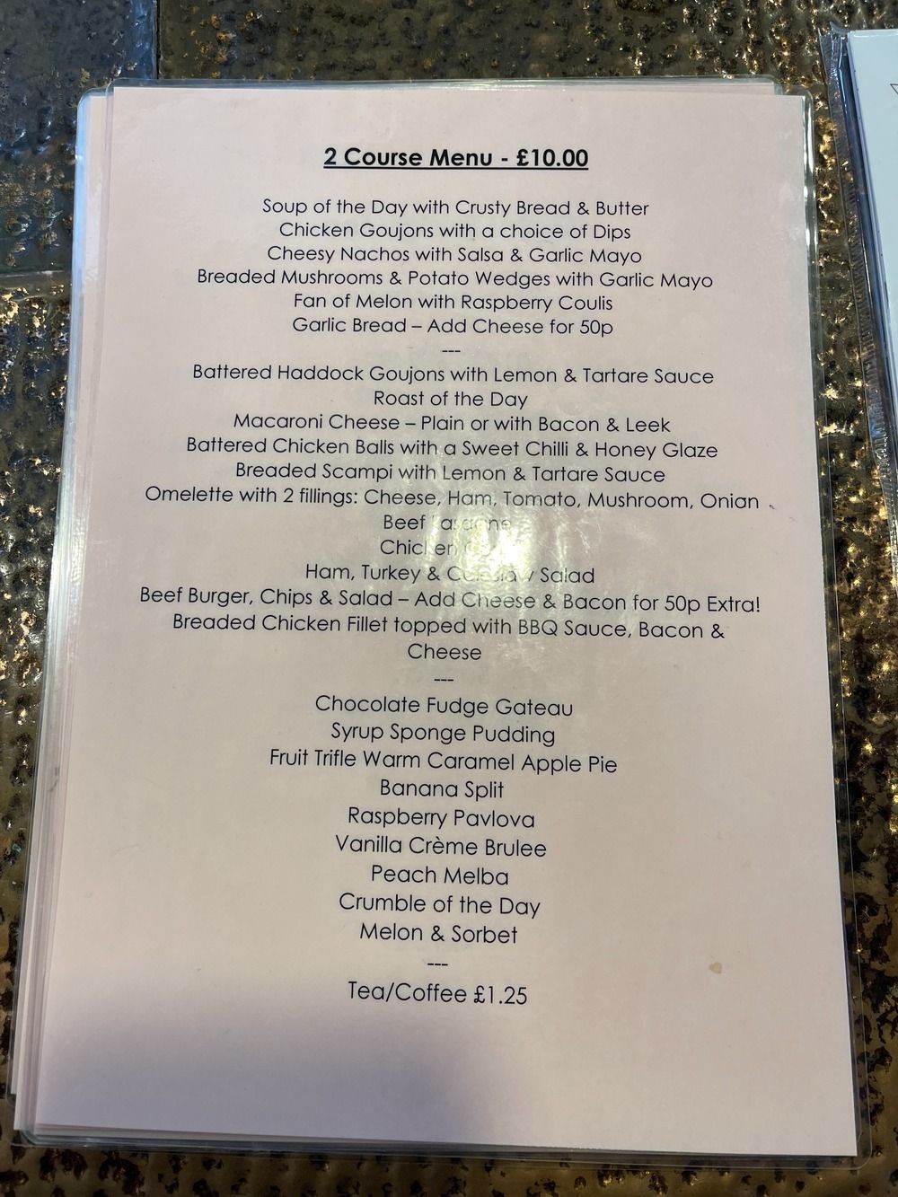 a menu for a restaurant is sitting on a table .