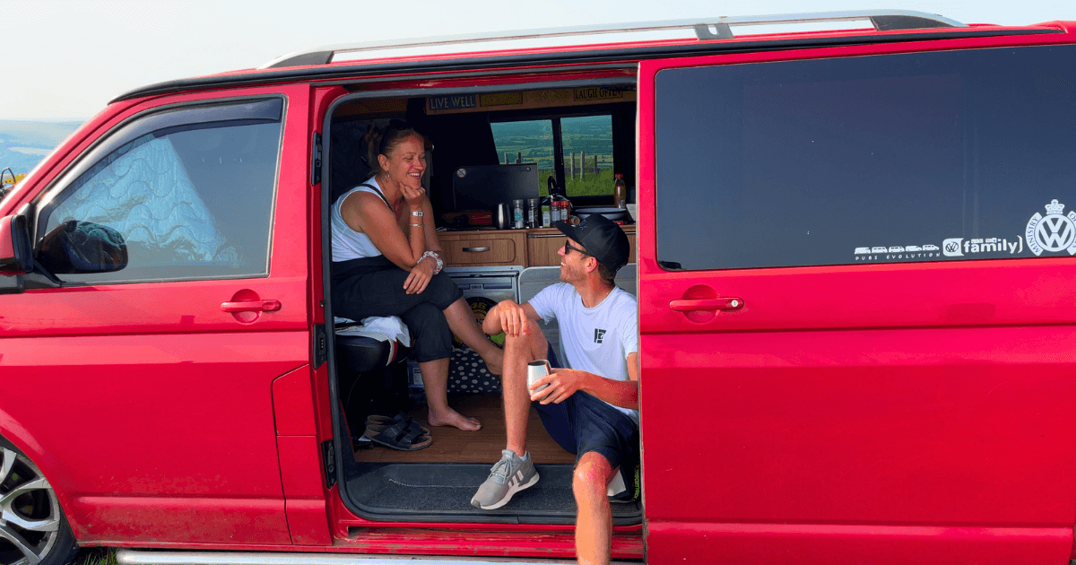 Trist & Kez sitting in a red van.