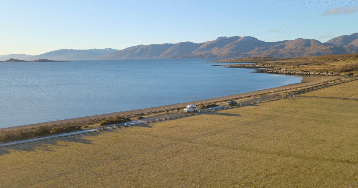 An aerial view of a Cuil Bay with mountains in the background.