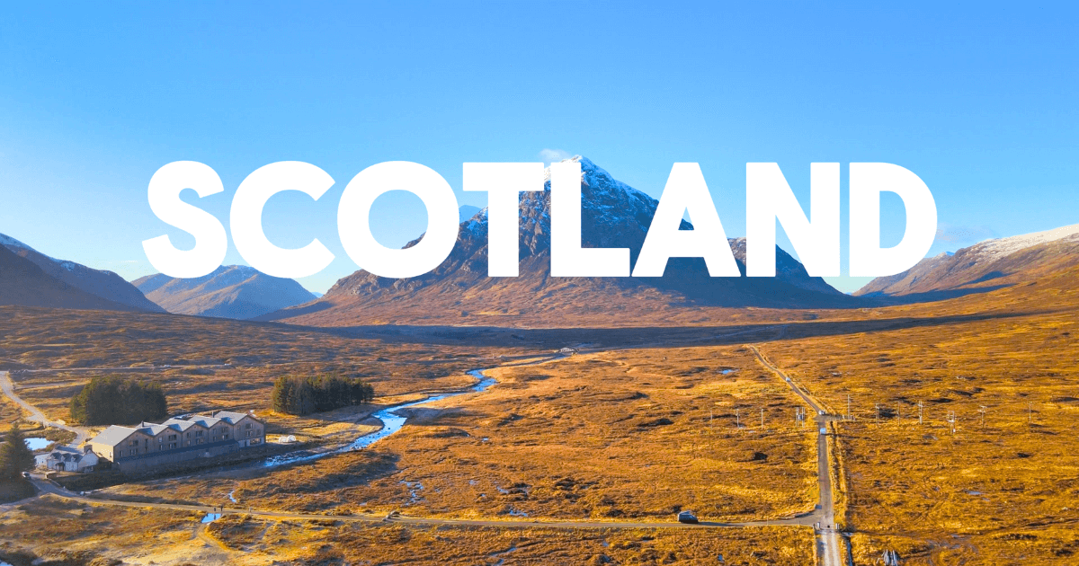 An aerial view of Scotland with mountains in the background.