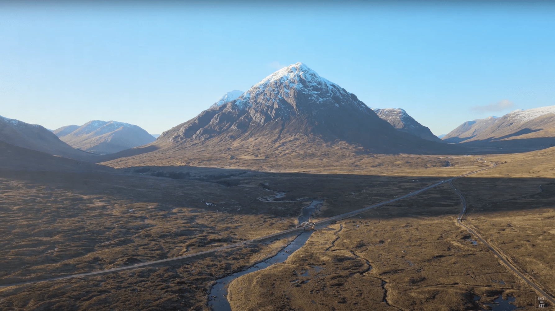 an aerial view of Glencoe mountain range with a river running through it.