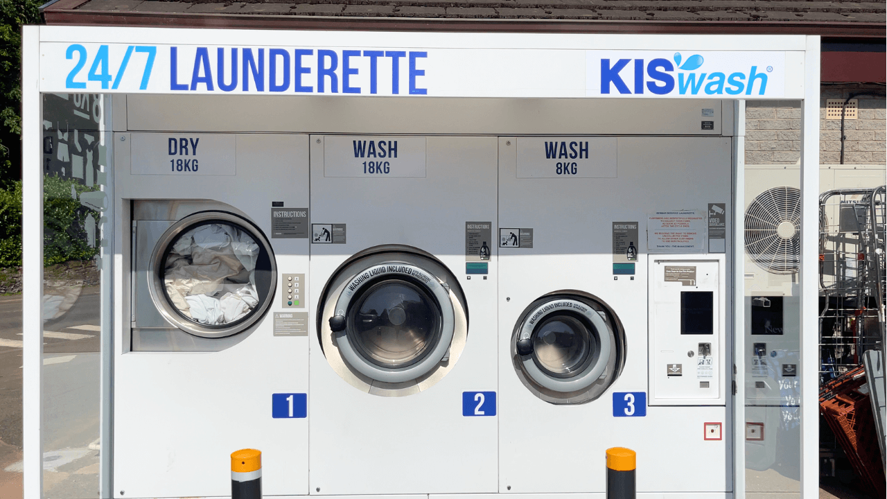 a 24/7 laundrette with three washers and three dryers