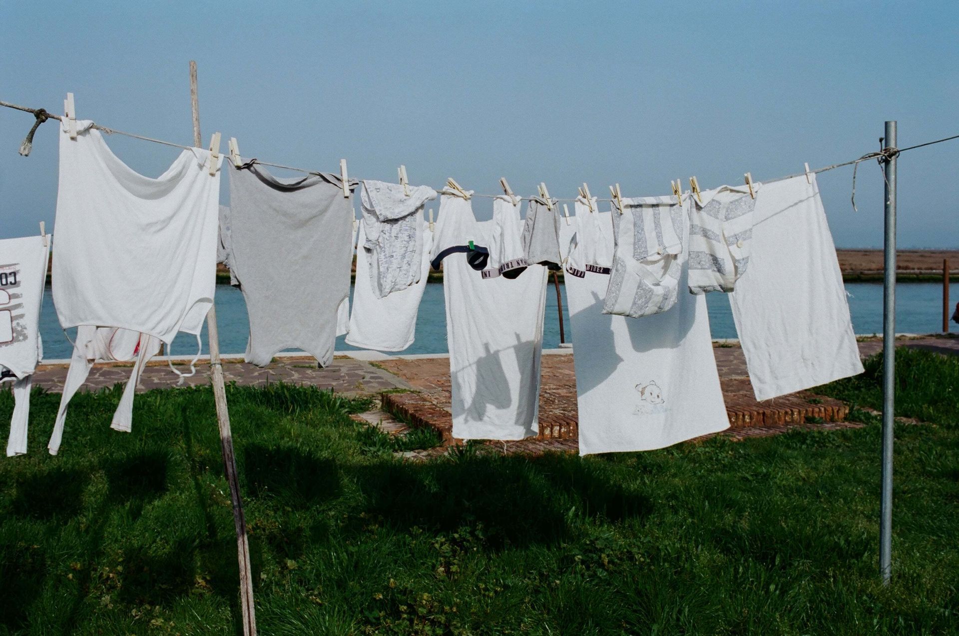 a bunch of white clothes are hanging on a clothes line .