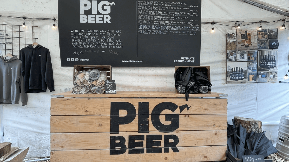 A wooden table with pig beer written on it