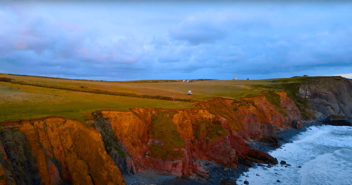 an aerial view of a cliff overlooking the ocean.