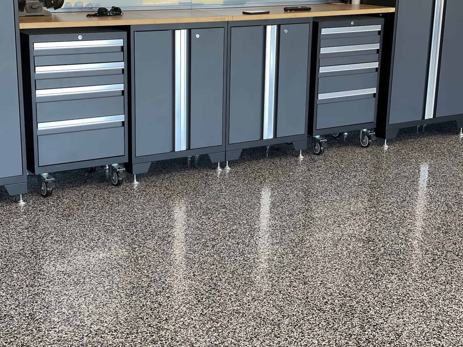 A garage with a lot of cabinets and drawers on the floor.