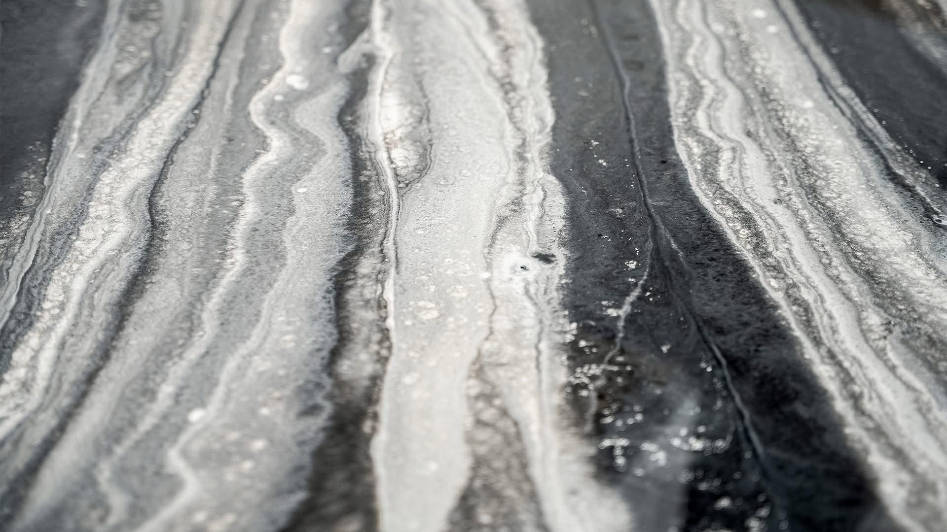 A black and white photo of a marble counter top.