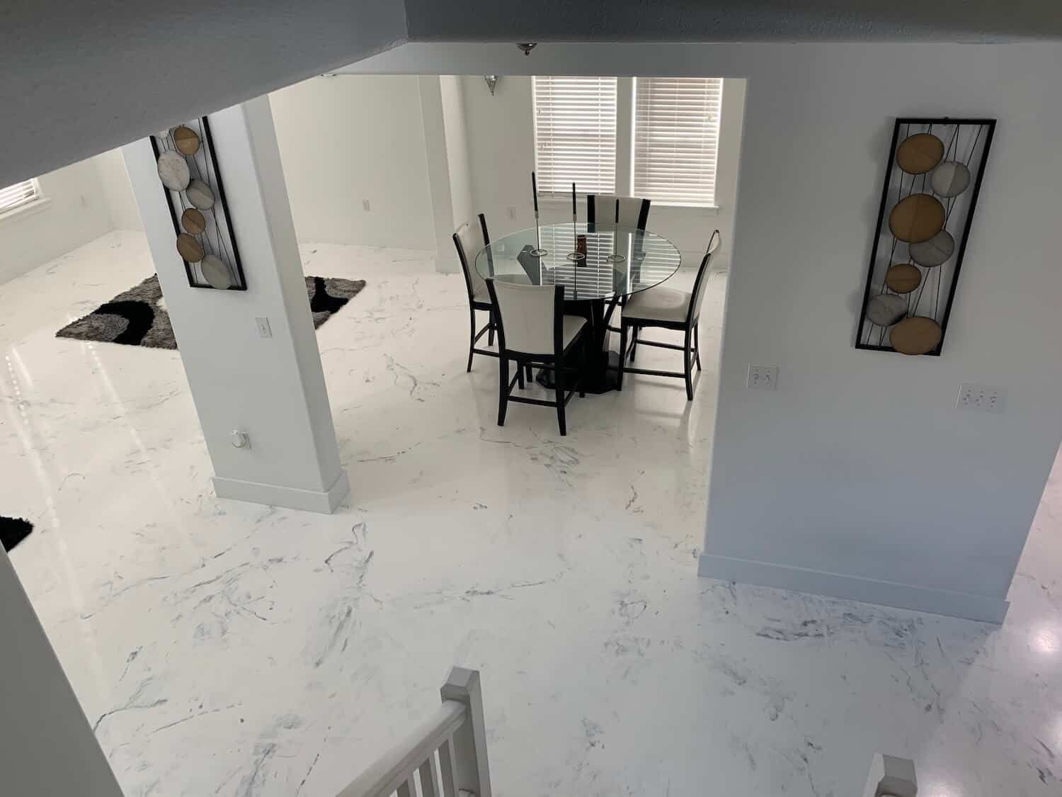 An aerial view of a dining room with a table and chairs.