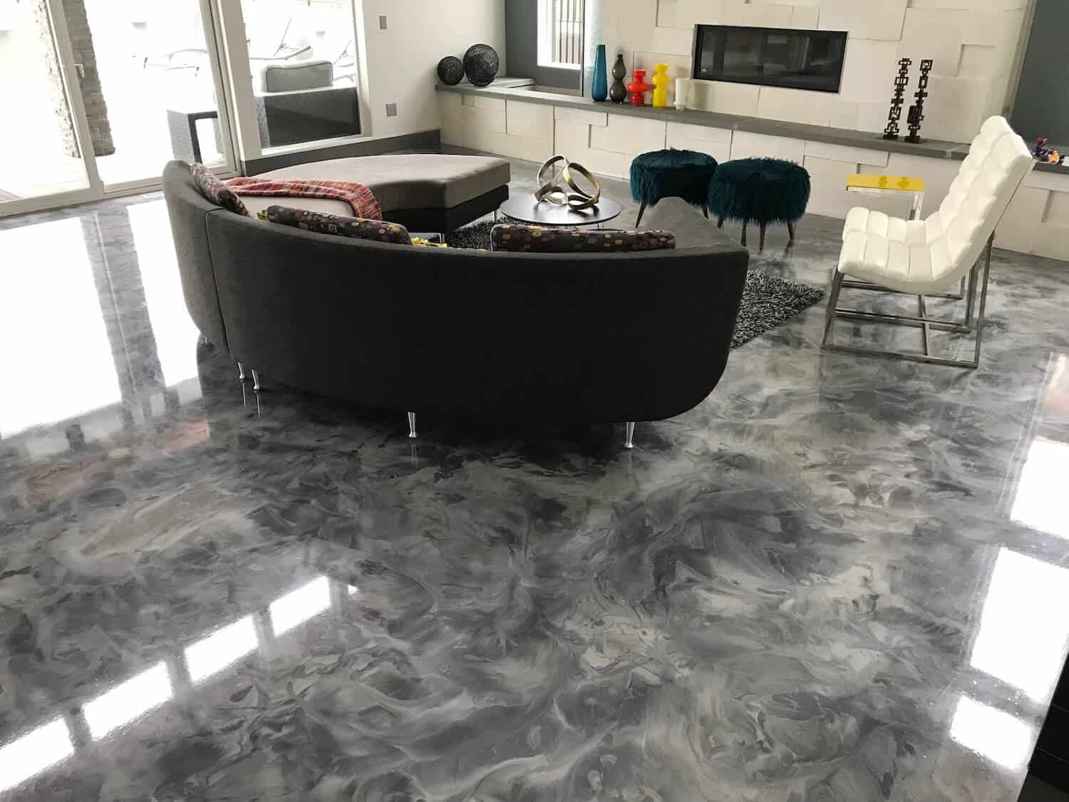 A living room with a couch , chairs , and a fireplace.