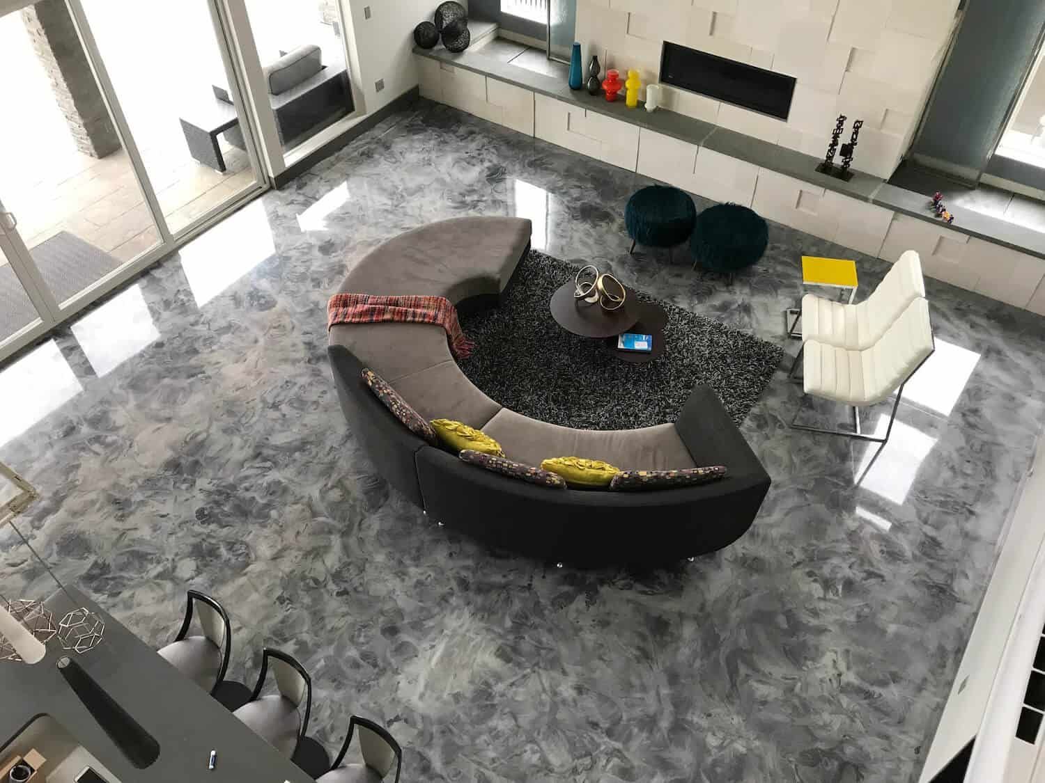 An aerial view of a living room with a curved couch and chairs.