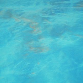 A person is swimming in a pool of blue water.