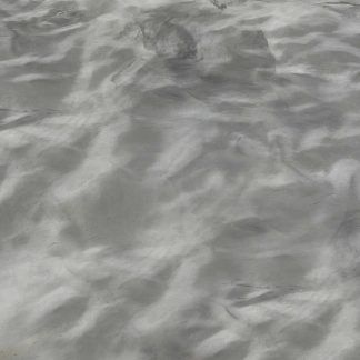 A close up of a gray concrete surface with waves on it.