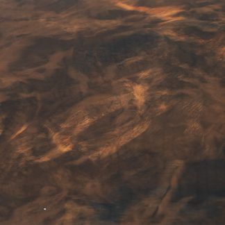 A close up of a brown surface with a swirl pattern.