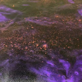 A close up of a purple and orange foam in a bathtub.