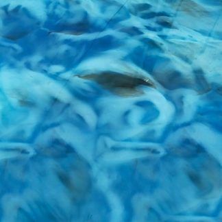 A close up of a blue and white marbled surface with a fish in the water.