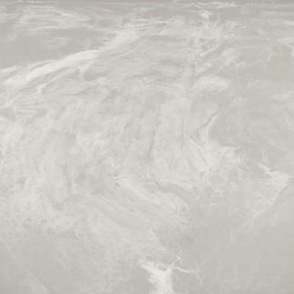 A close up of a gray concrete floor with a marble texture.