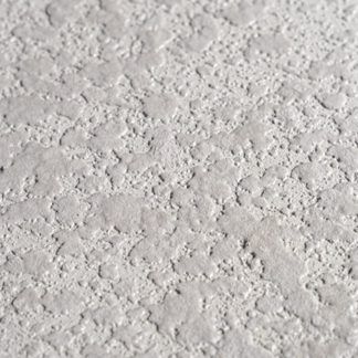 A close up of a white wall with a rough texture.