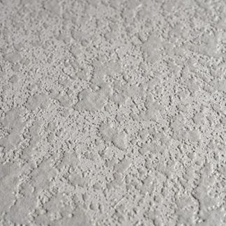 A close up of a white wall with a texture.