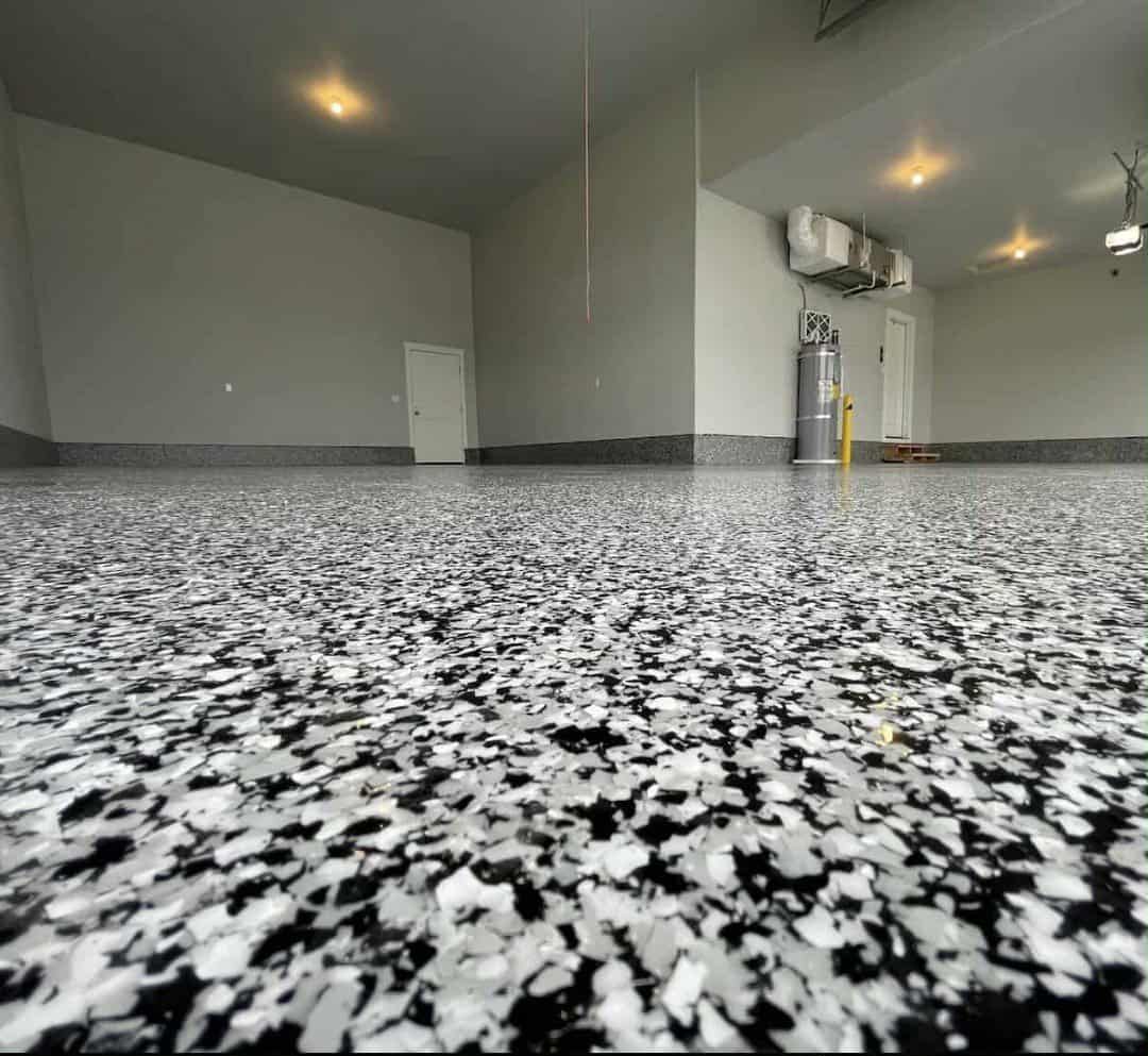 A close up of a black and white floor in a garage.