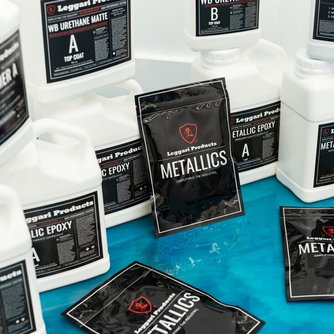 A bunch of bottles and bags of metallics are sitting on a table.