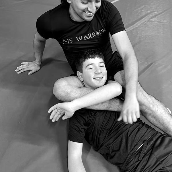 two men practicing a jiu jitsu grappling hold
