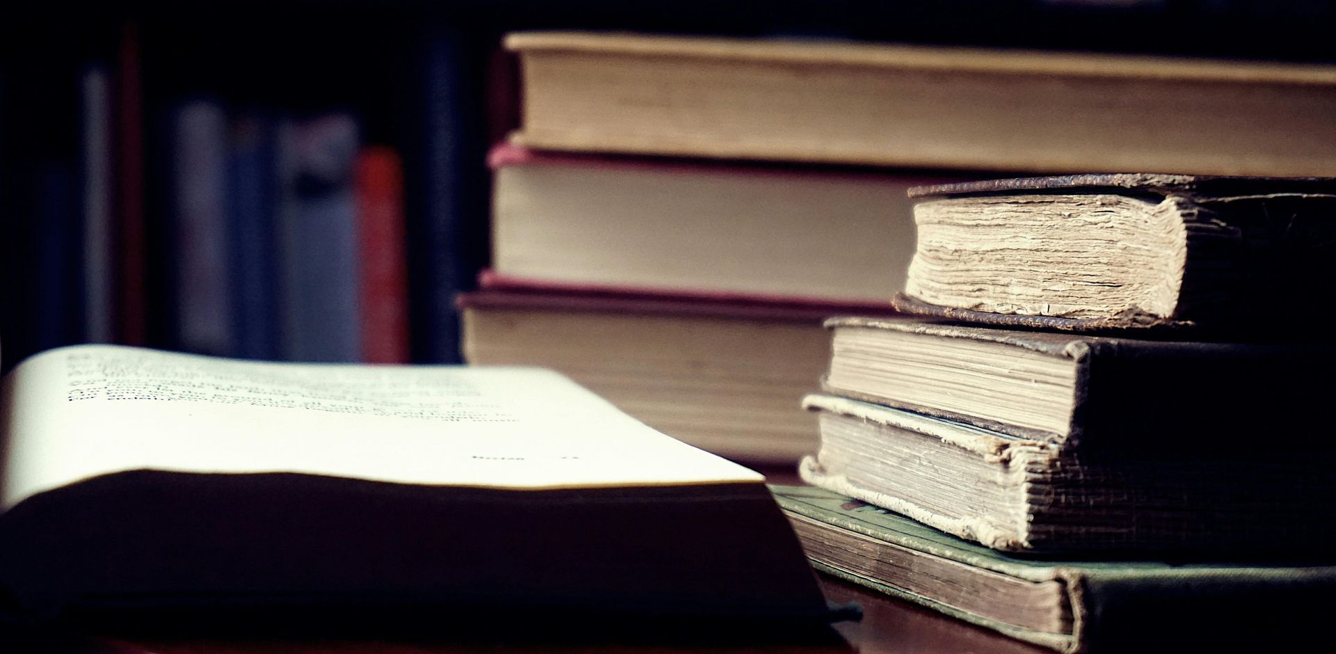 A stack of books sitting on top of each other on a table.