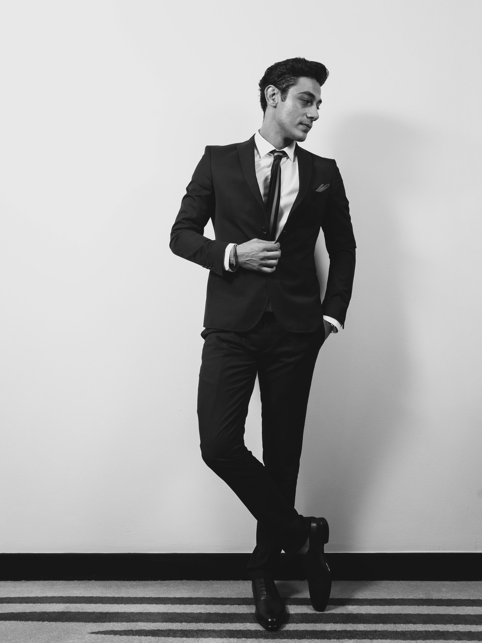 A black and white photo of a man in a suit and tie