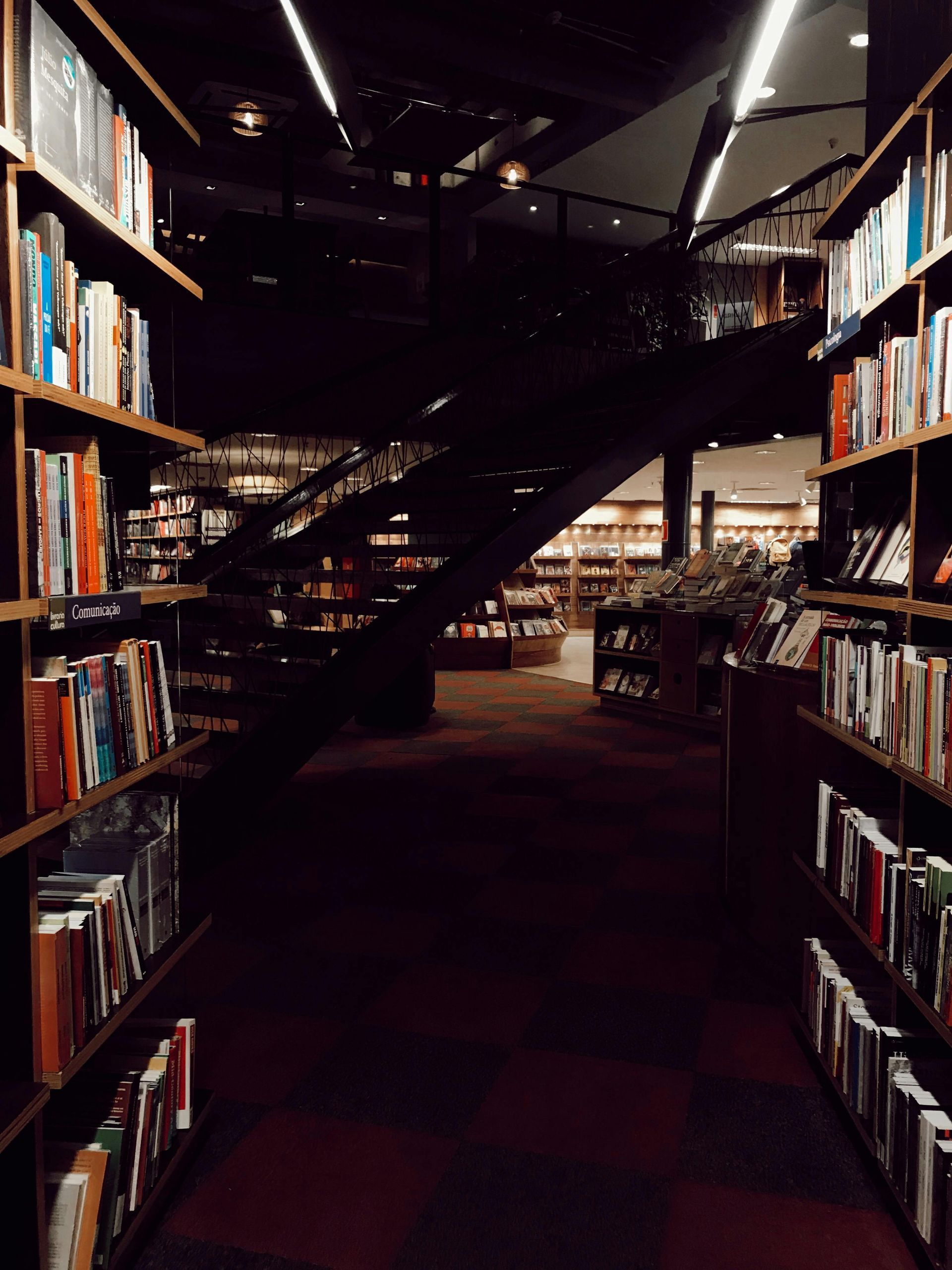 A bookstore with a staircase going up to the second floor