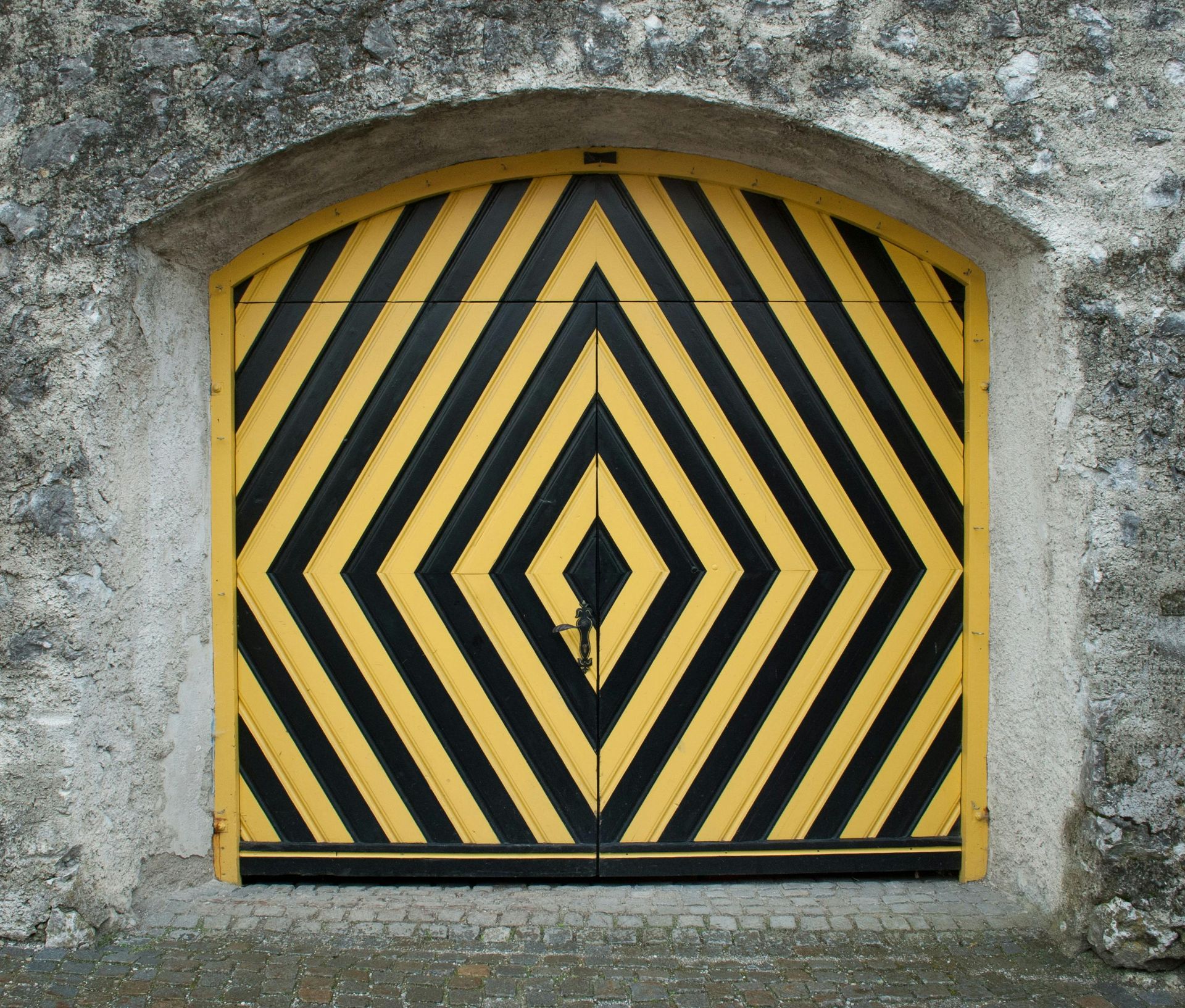 A yellow and black door with a diamond pattern