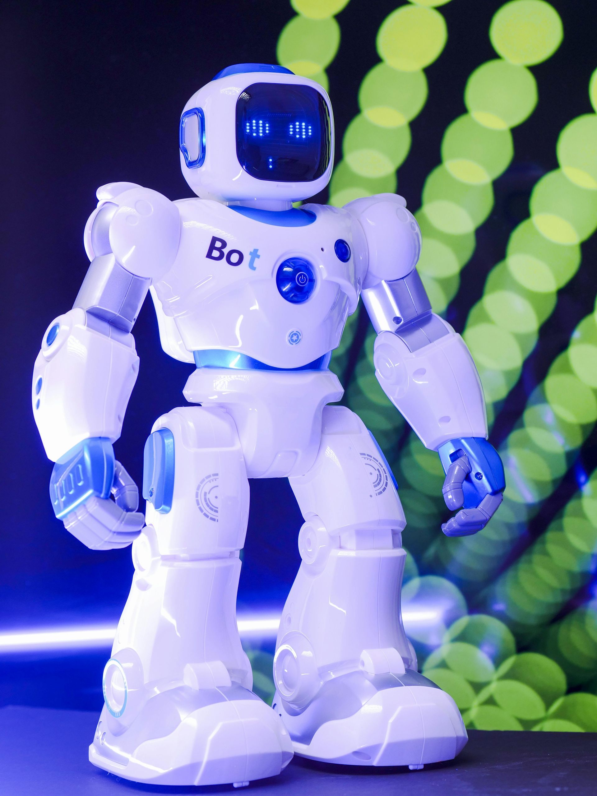 A white and blue robot with the word bot on it