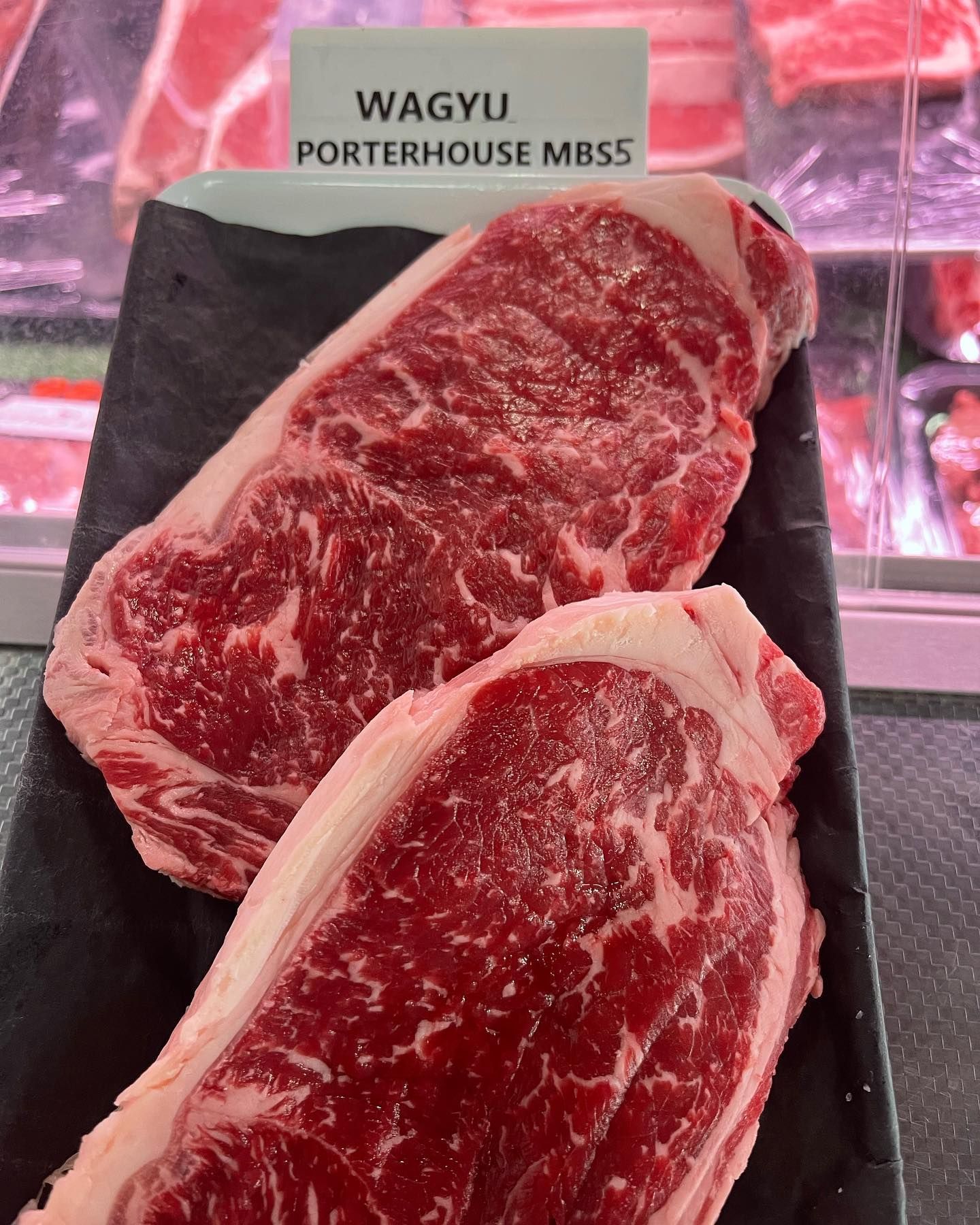 Two wagyu steaks are on a black plate — Lakim Butcher In Parap, NT