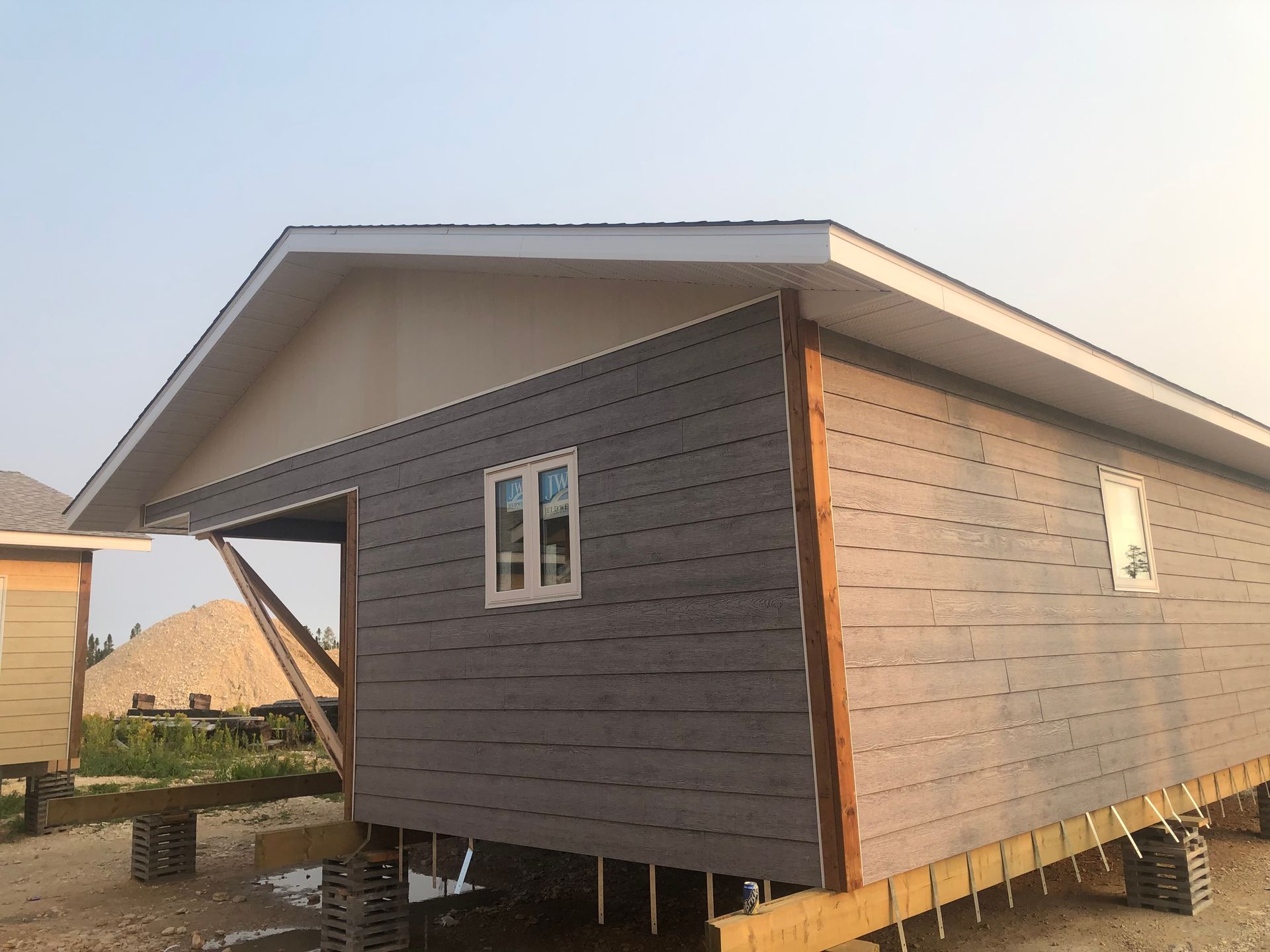 Yellow construction crane framing the One World Trade Center skyscraper in New York City.