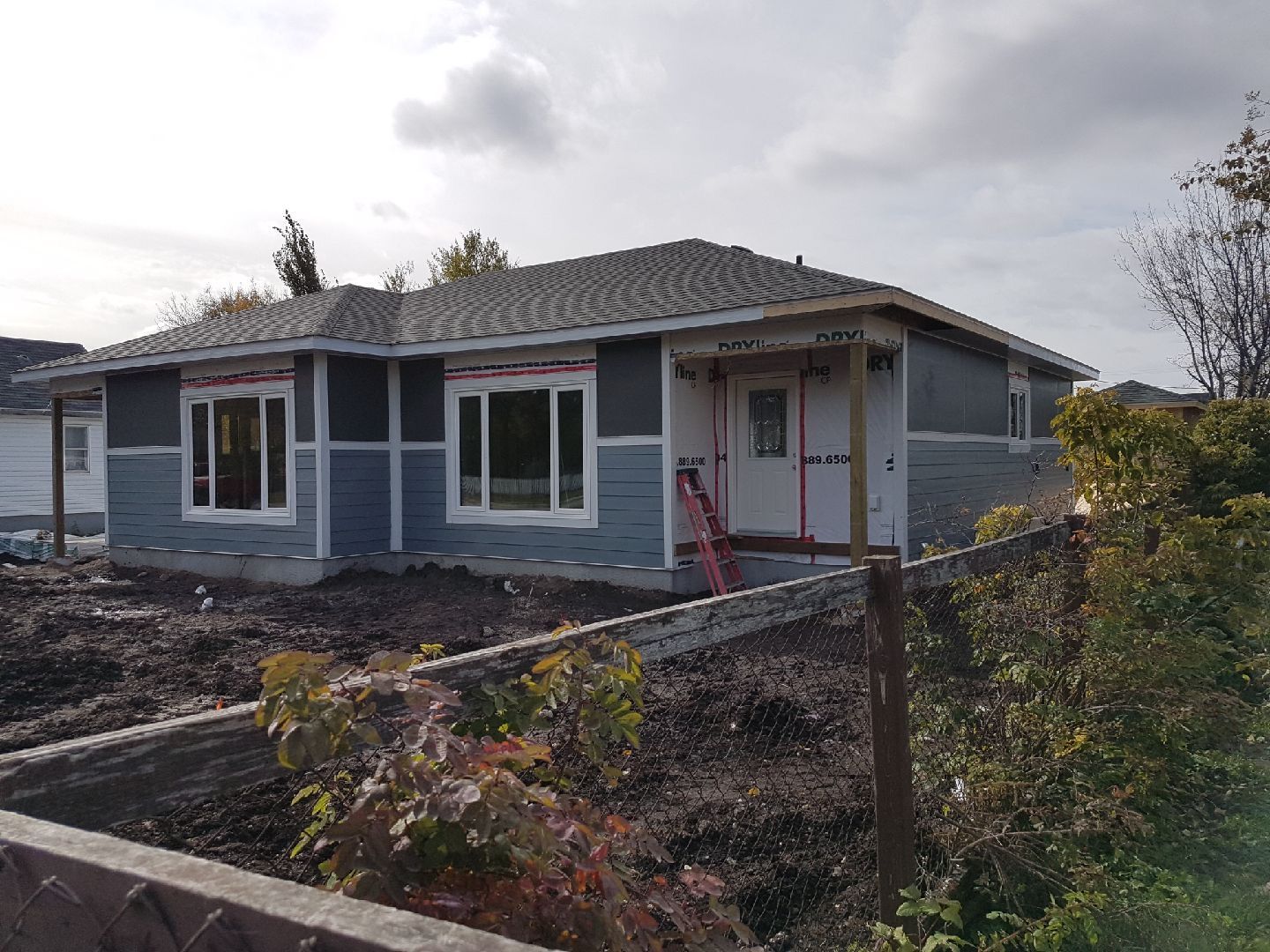 Diagonal view of a roof with two color sections: gray tiles on the left and orange tiles on the right.
