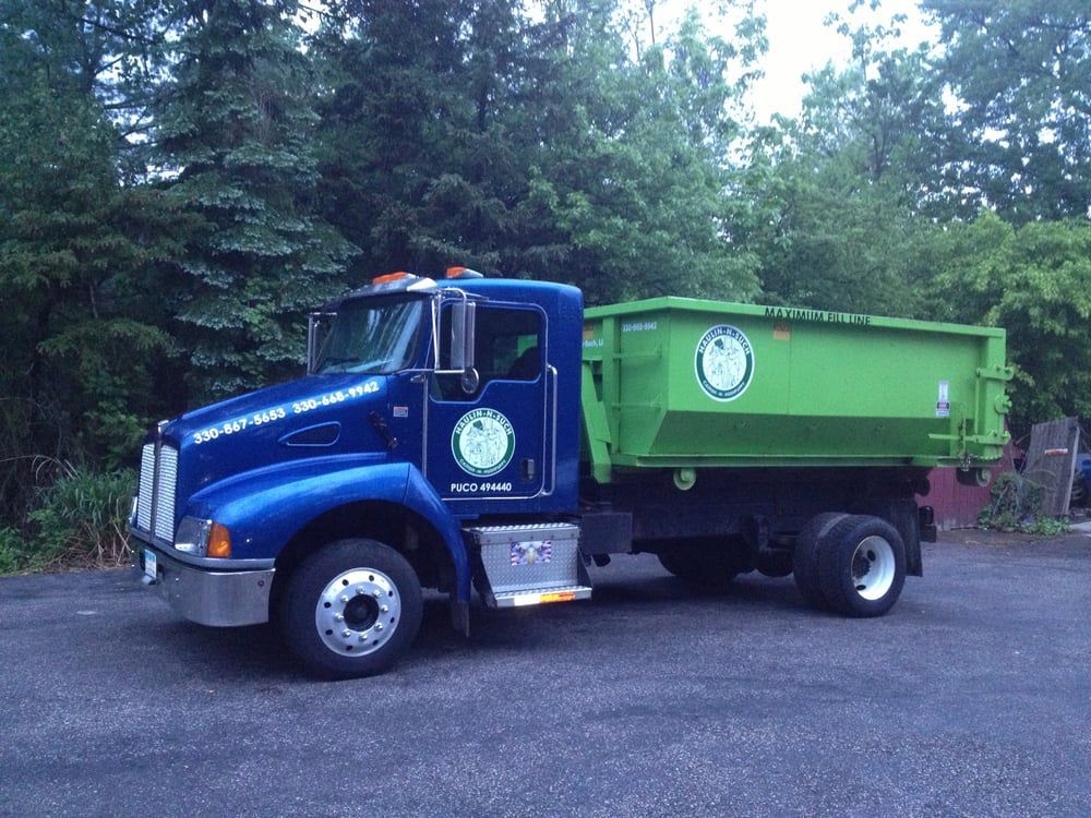 One of our trucks making a dumpster delivery