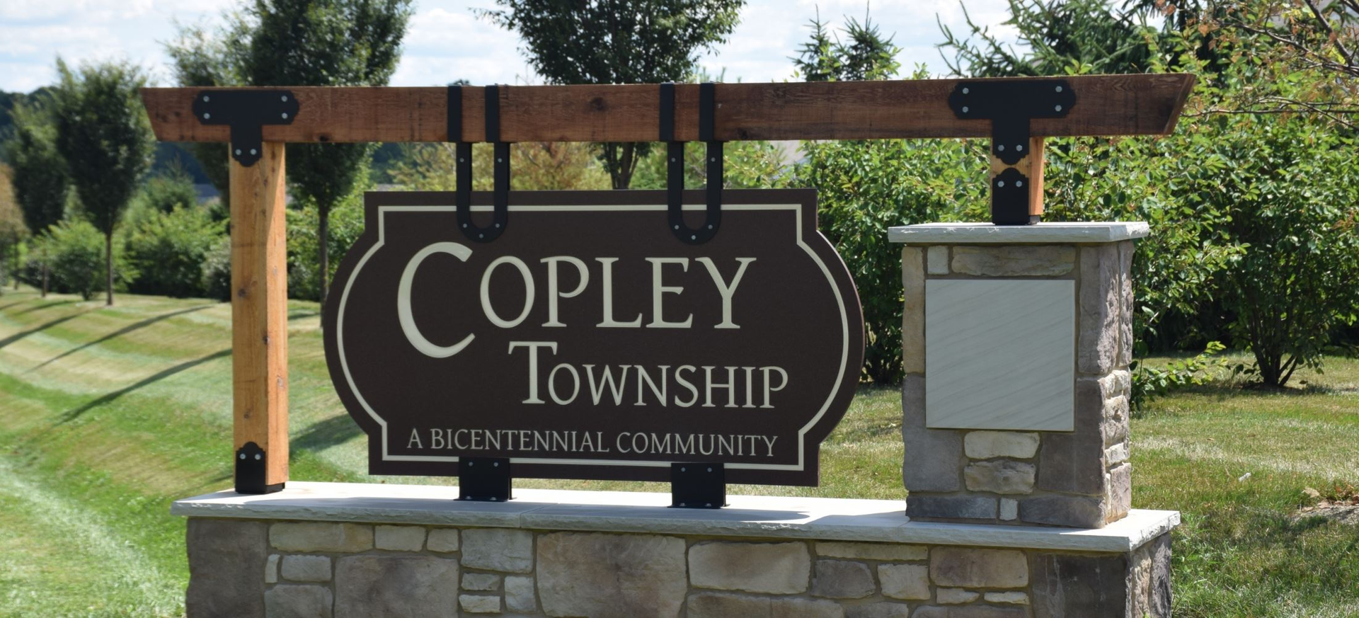 A brown wooden sign reads 