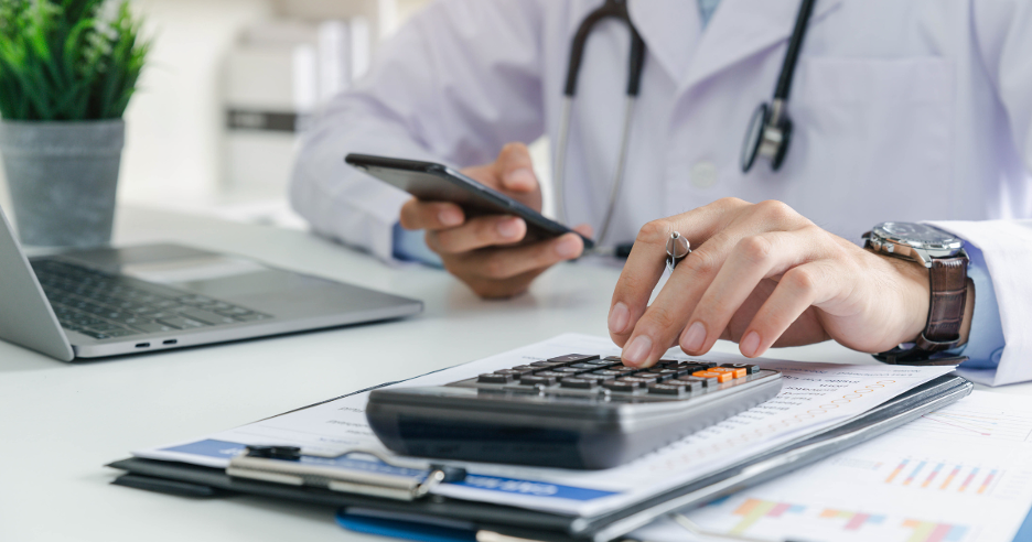 A doctor reviewing telehealth billing details on a smartphone while calculating medical costs, highl