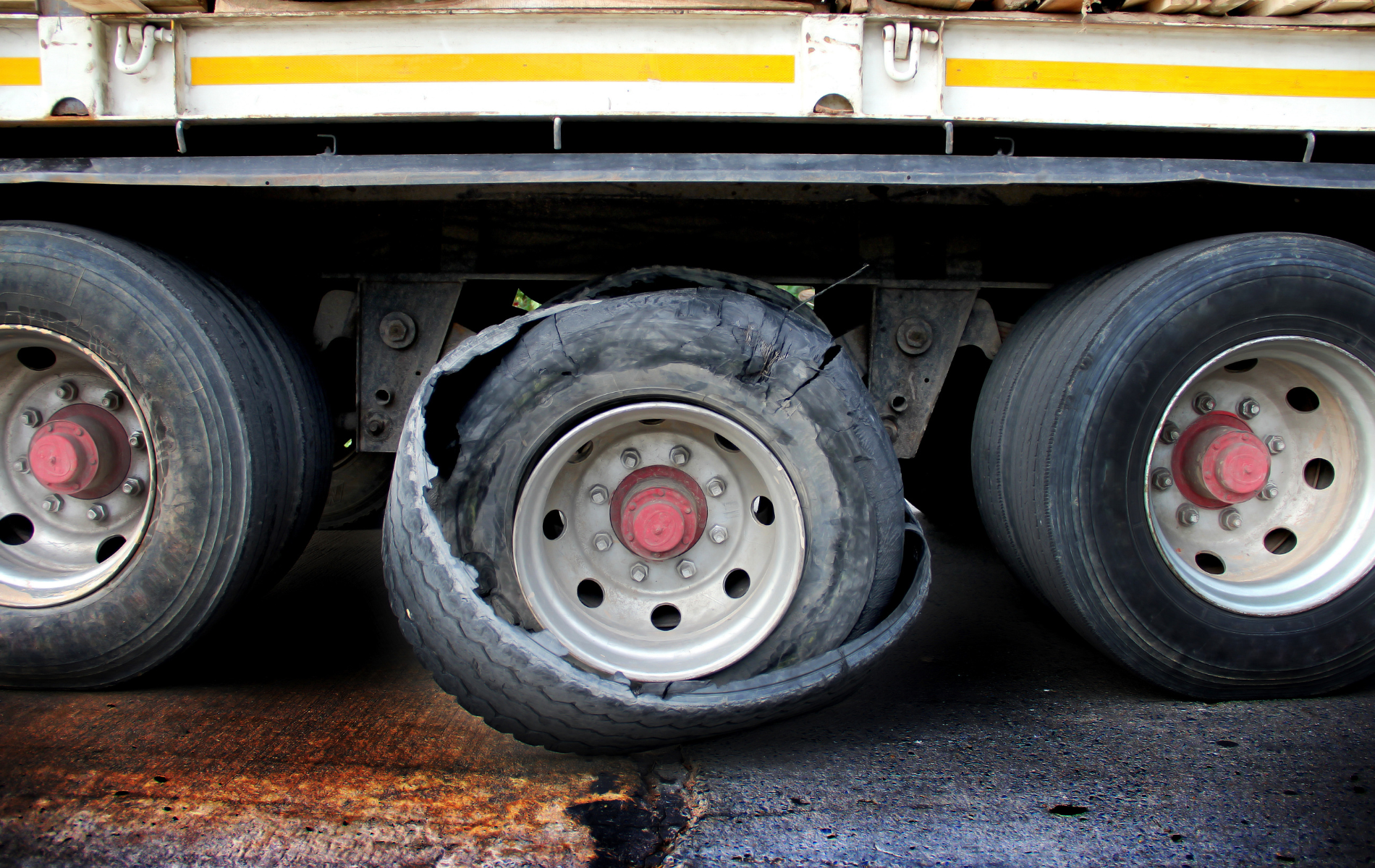 A truck with a flat tire on the back of it.