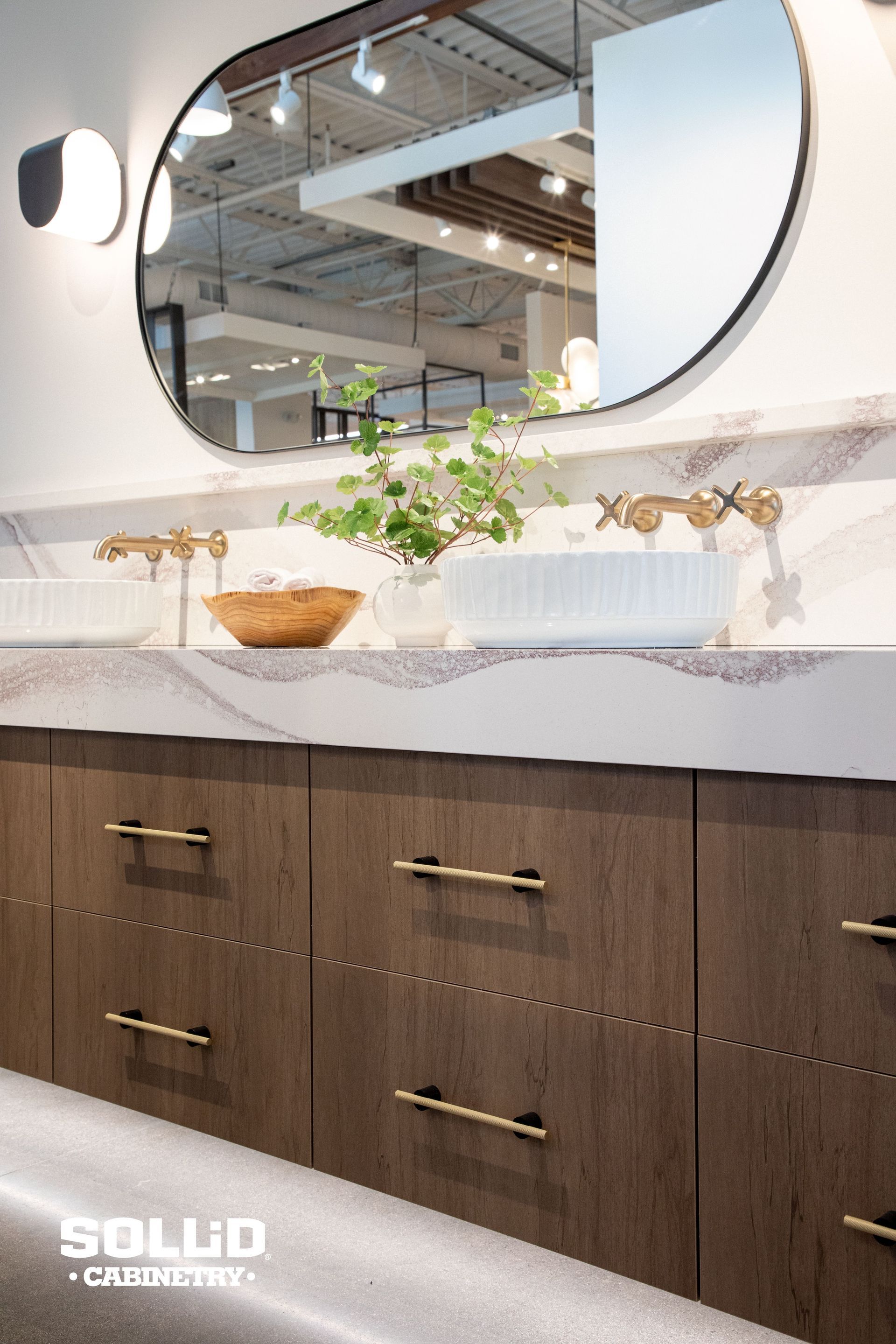 A bathroom with two sinks and a large mirror.