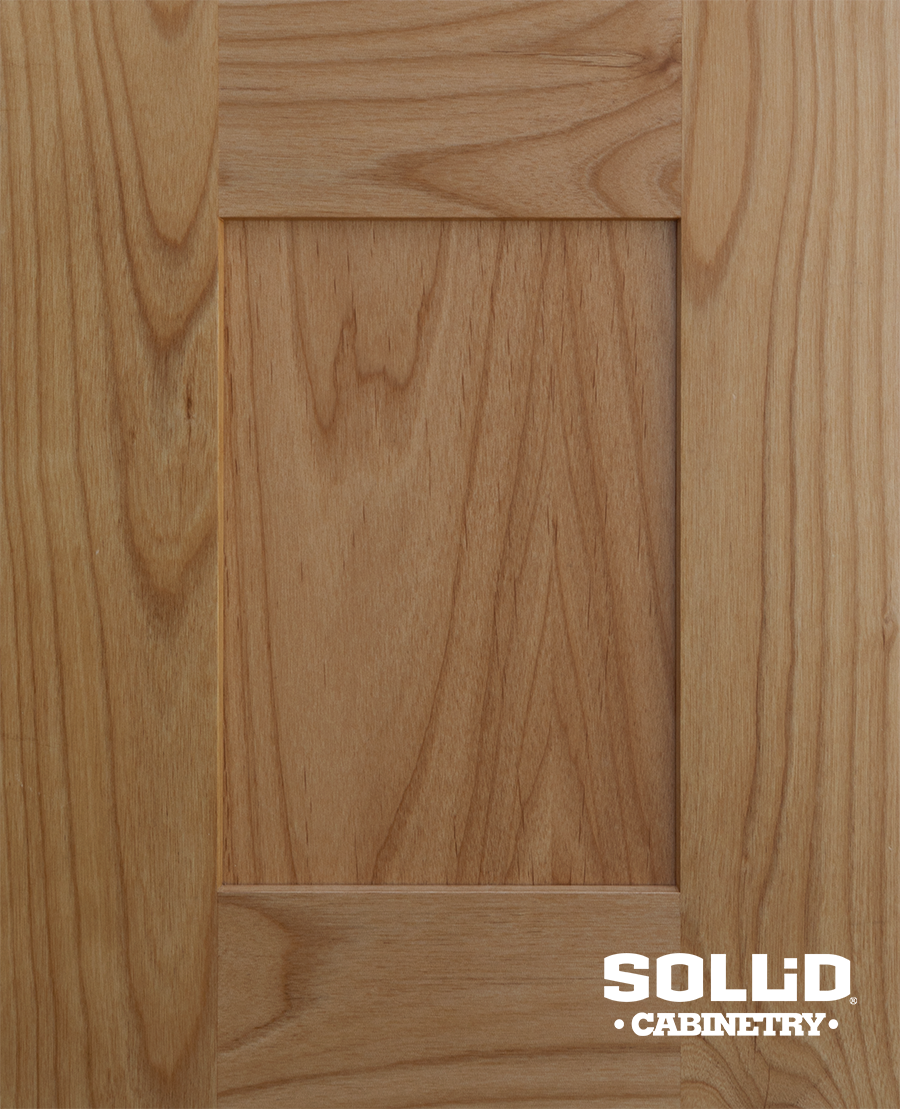 A close up of a solid cherry cabinet door