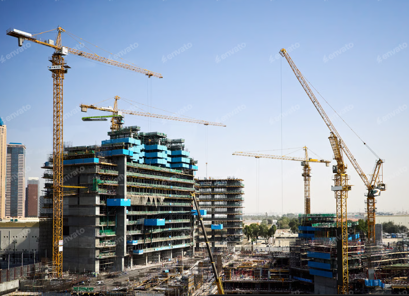 A construction site with lots of cranes and buildings under construction