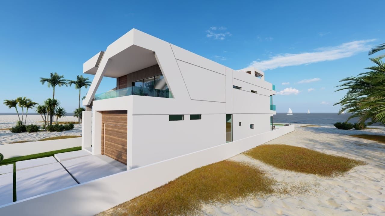 A white house is sitting on top of a sandy beach next to the ocean.