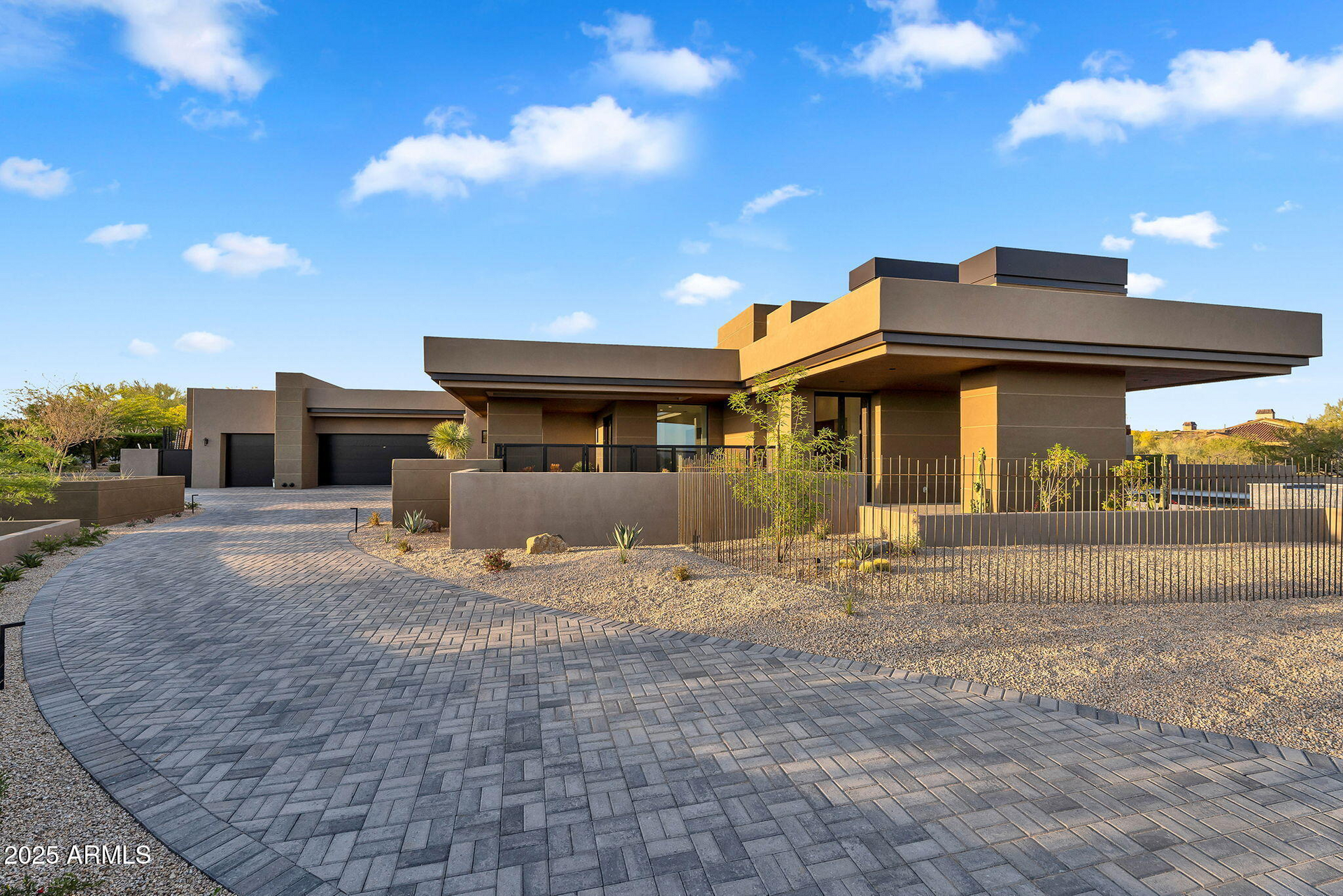 A large house with a brick driveway in front of it