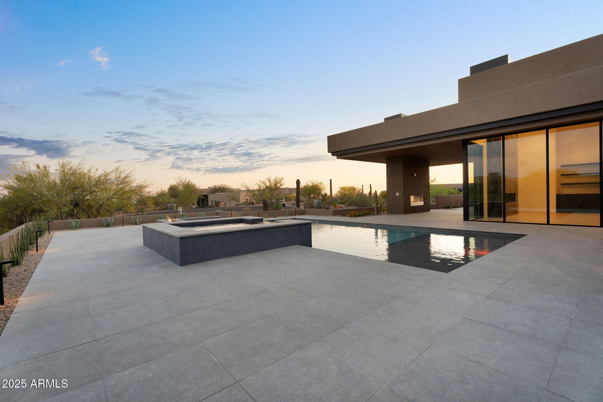 A large house with a swimming pool in front of it
