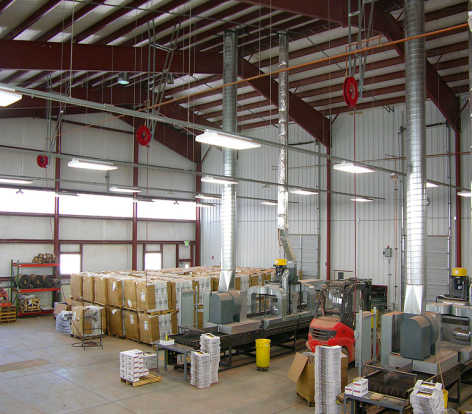 A large warehouse filled with lots of boxes and machinery