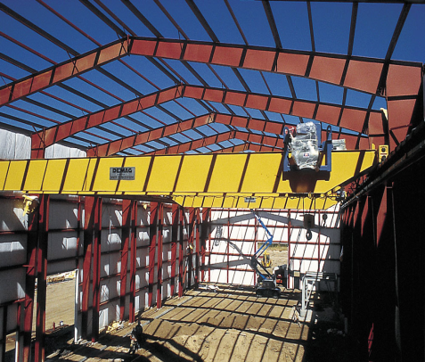 A large building under construction with a yellow crane in the middle