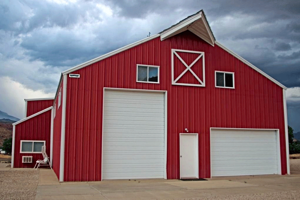 A large red barn with white doors and windows.