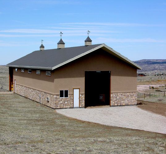A large brown building with three chimneys on the roof