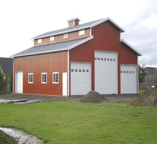 A large red barn with white garage doors