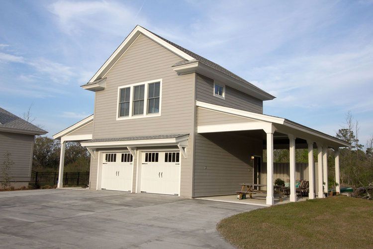 A house with two garage doors and a carport